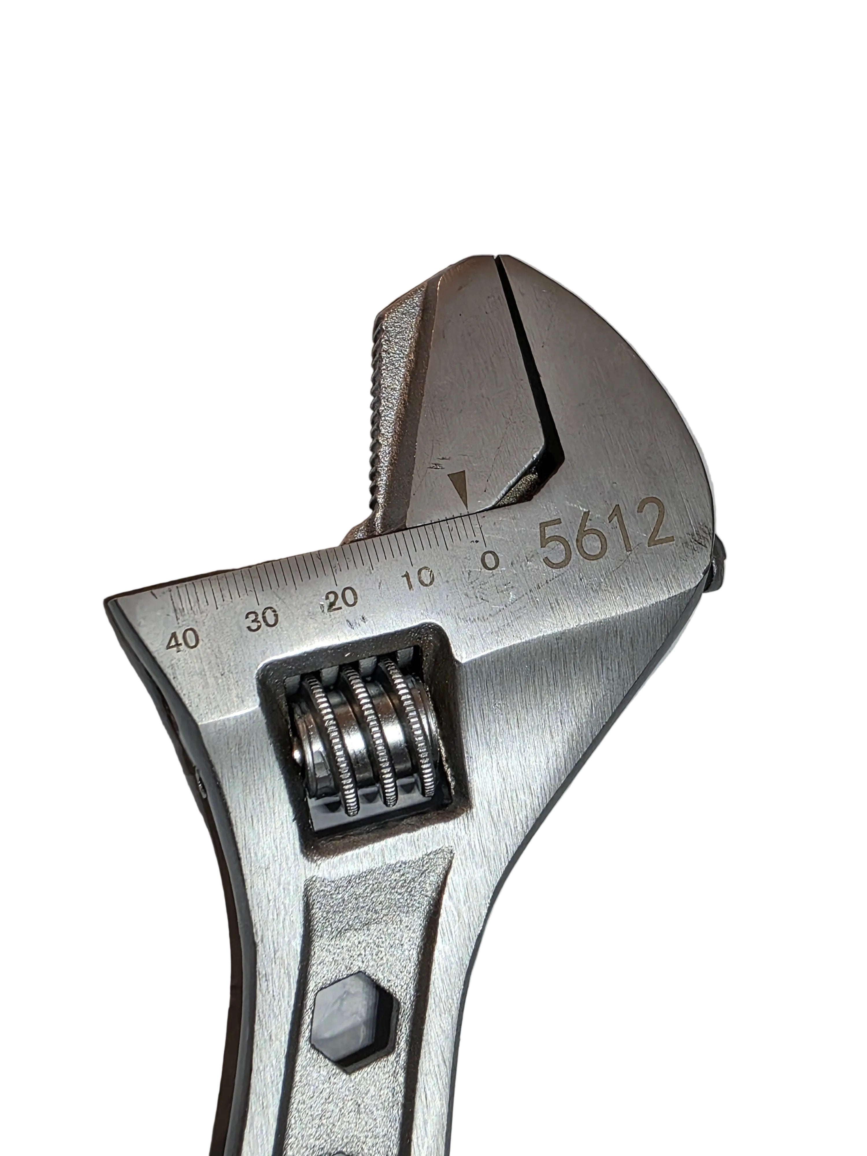 Silver adjustable wrench on a textured gray surface