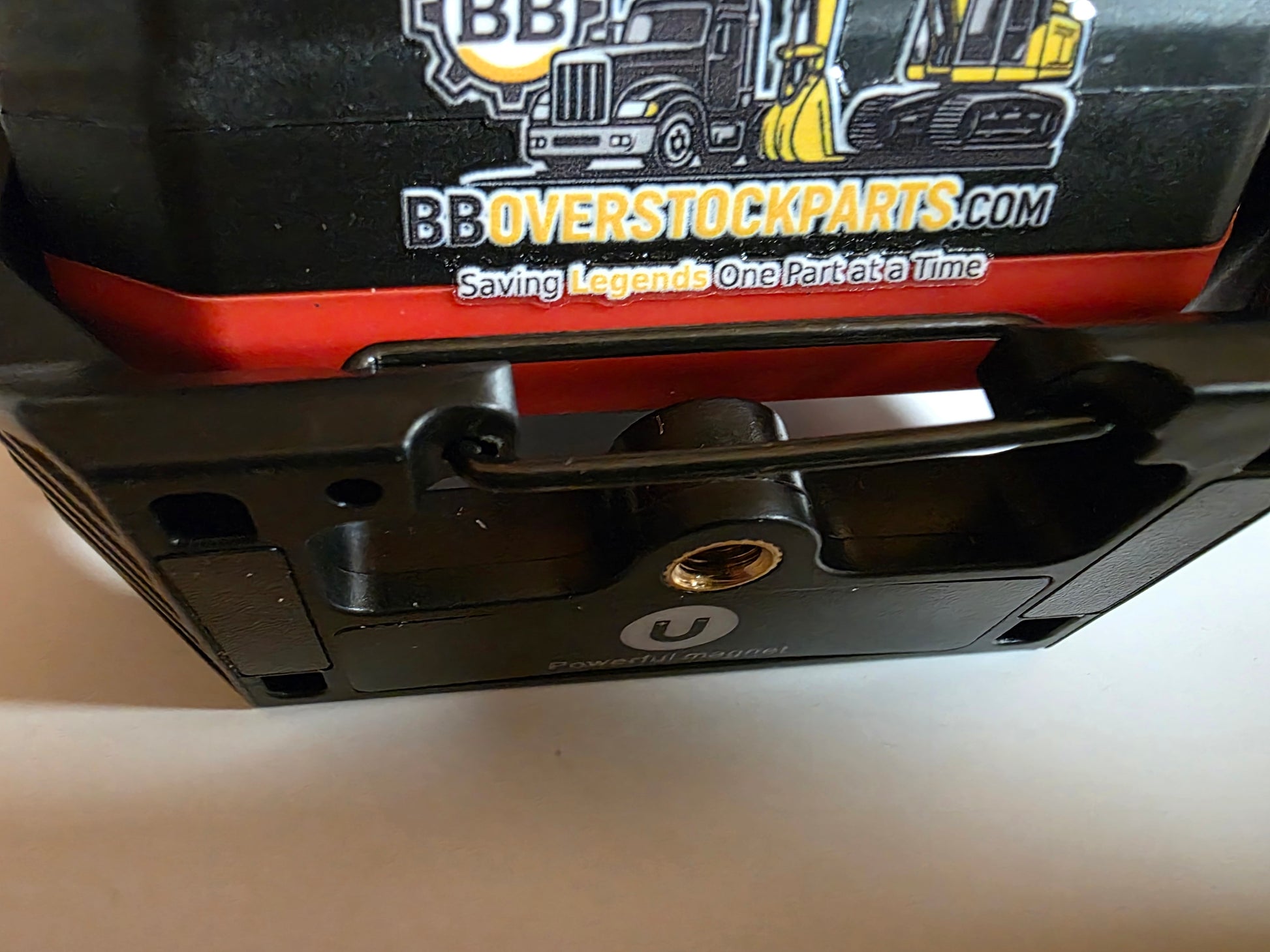 Work light base showing aluminum slip 1/4-20 screw hole and powerful magnet with logo
