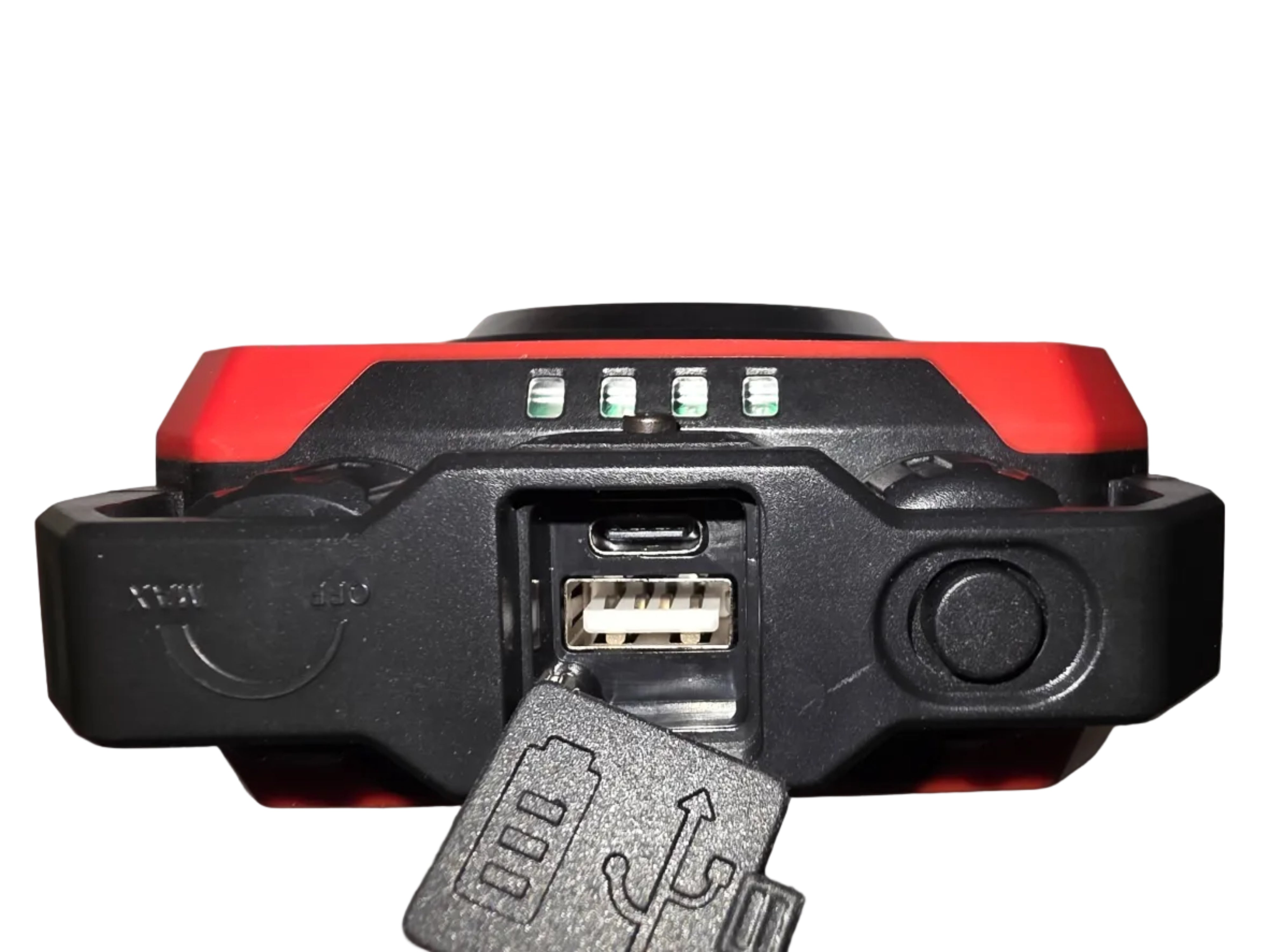 Close-up of a red and black electronic device with USB and micro USB ports on a gray background
