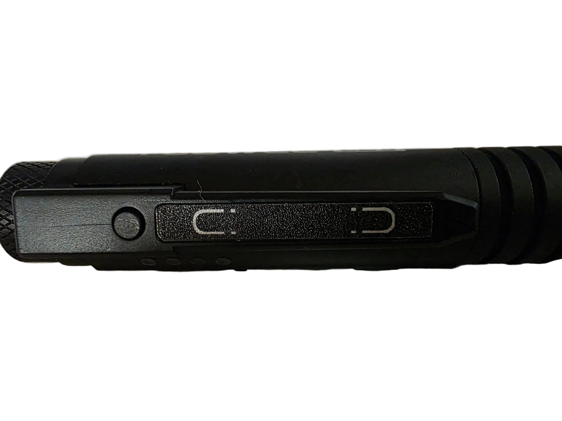 Close-up of a black cylindrical flashlight or tool showing a textured grip, a side button, and two switch slots on a plain light background.