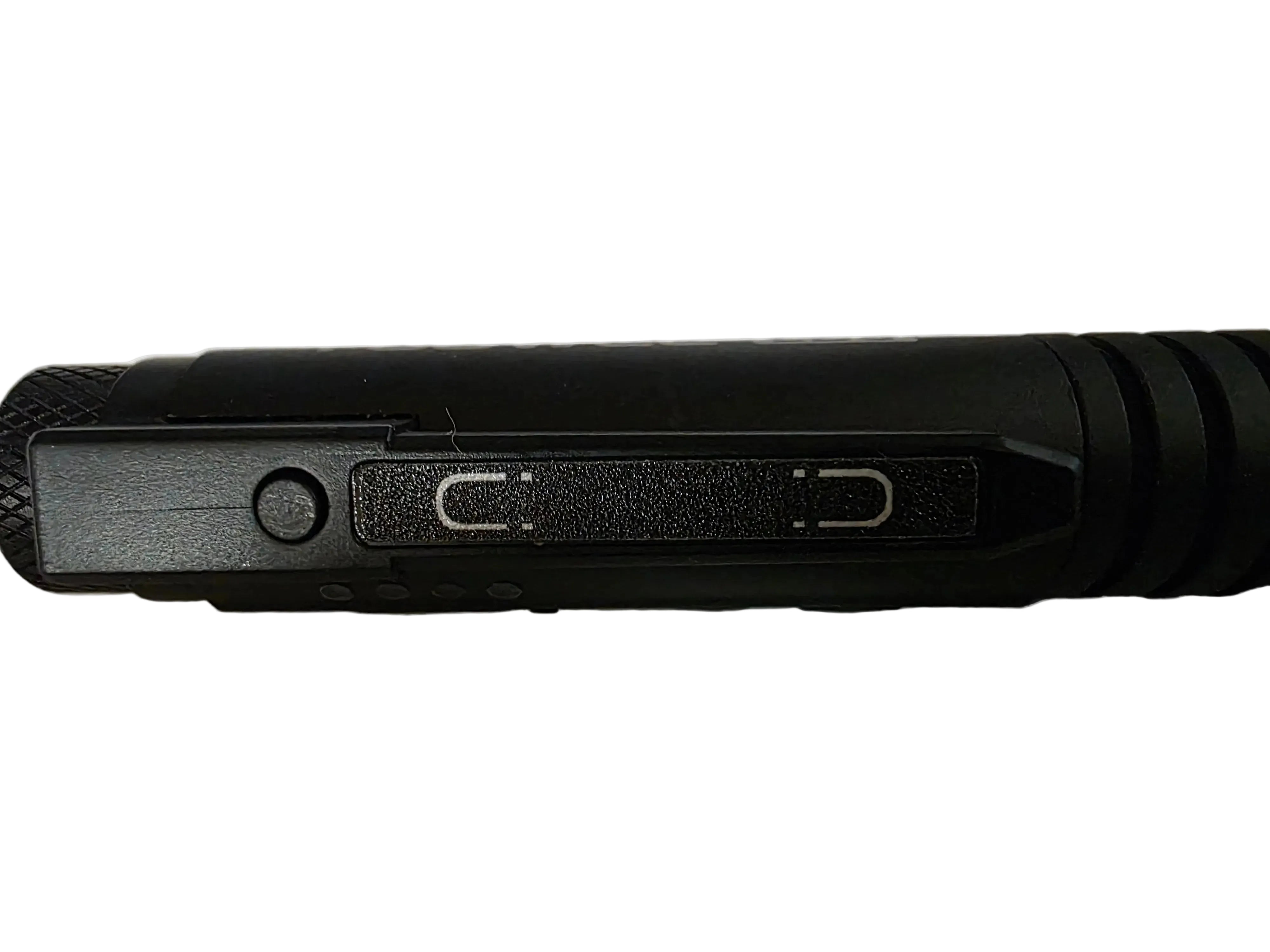 Close-up of a black cylindrical flashlight or tool showing a textured grip, a side button, and two switch slots on a plain light background.