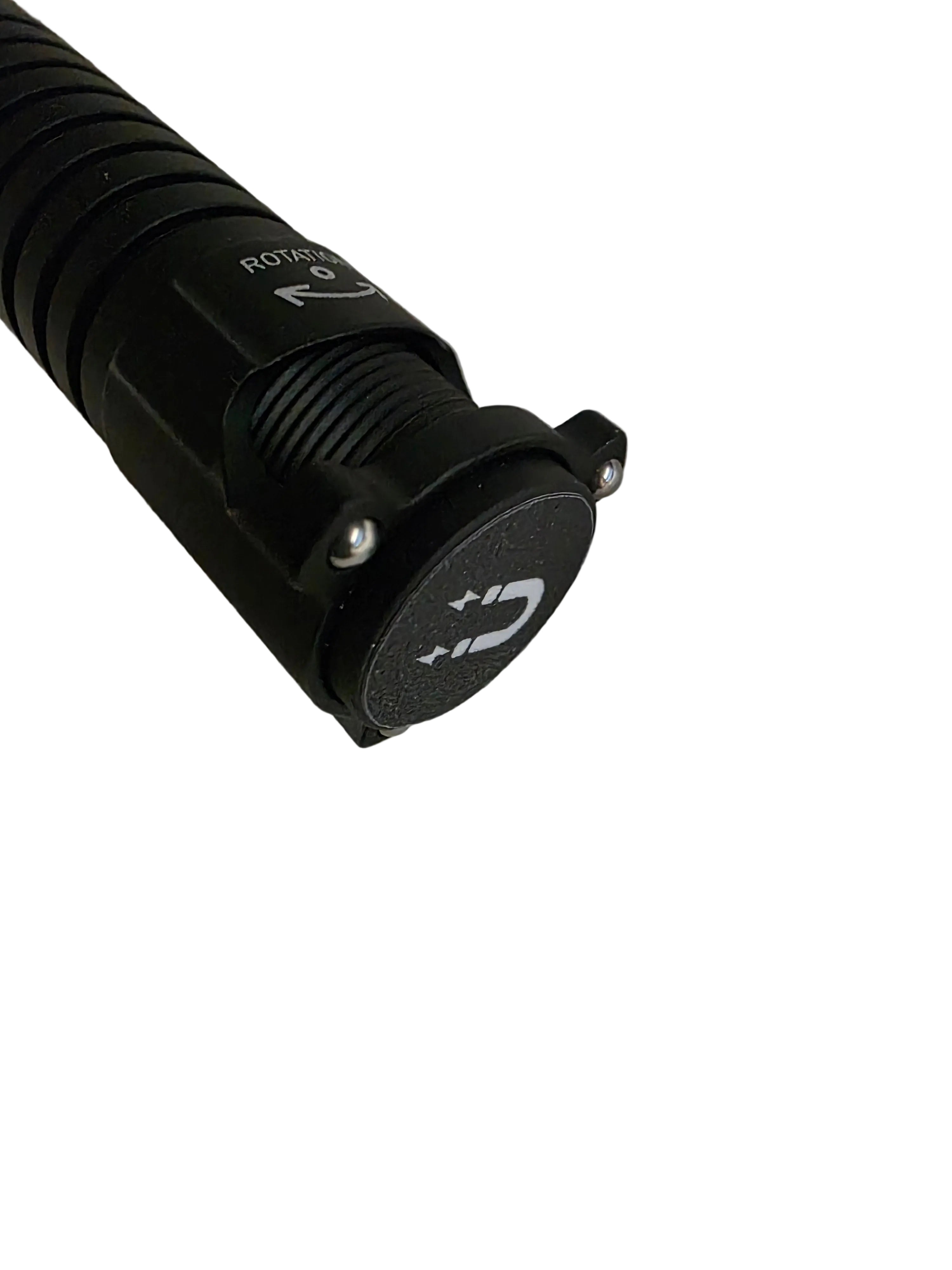 A close-up of a black cylindrical flashlight or tool with a textured grip, a ridged collar, and a circular top cap featuring a white magnetic symbol, photographed on a plain light background.
