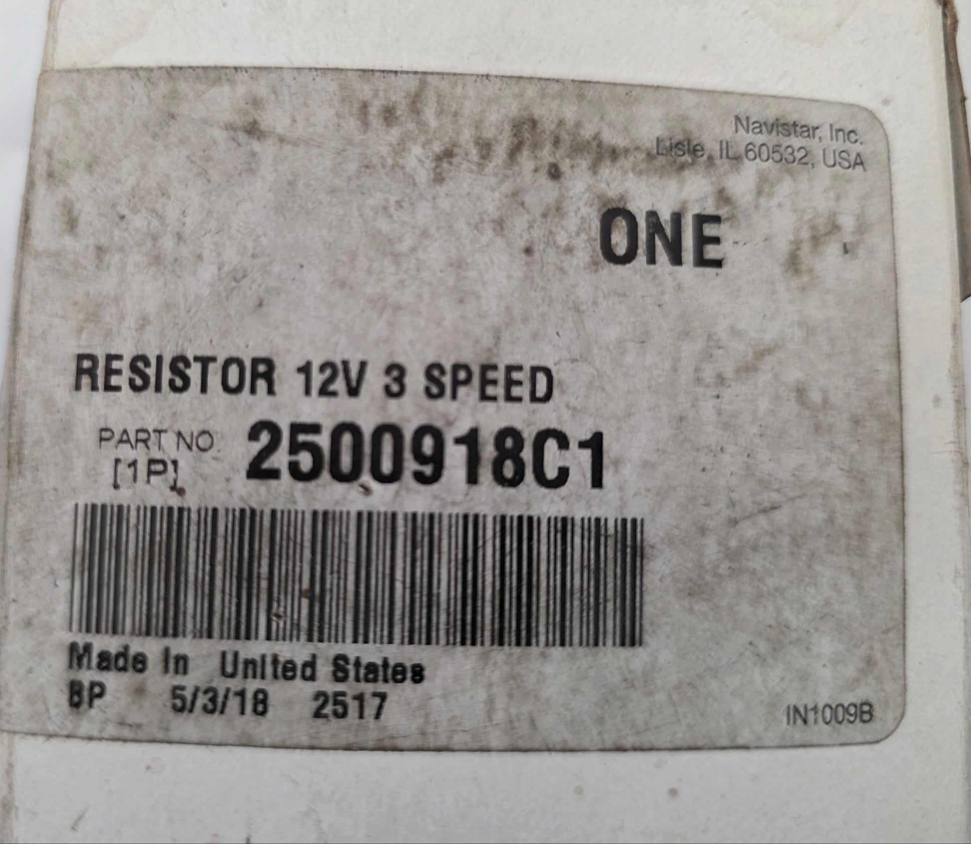 A close-up of a white plastic component box with a printed label reading 'RESISTOR 12V 3 SPEED', 'ONE', and 'PART NO 2500918C1' with a barcode.