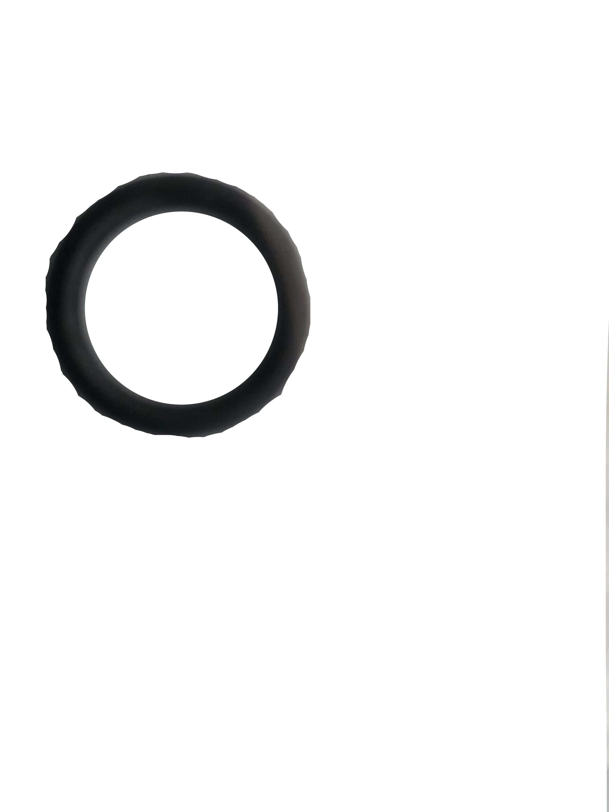 A black rubber O-ring resting on a crumpled translucent plastic surface.