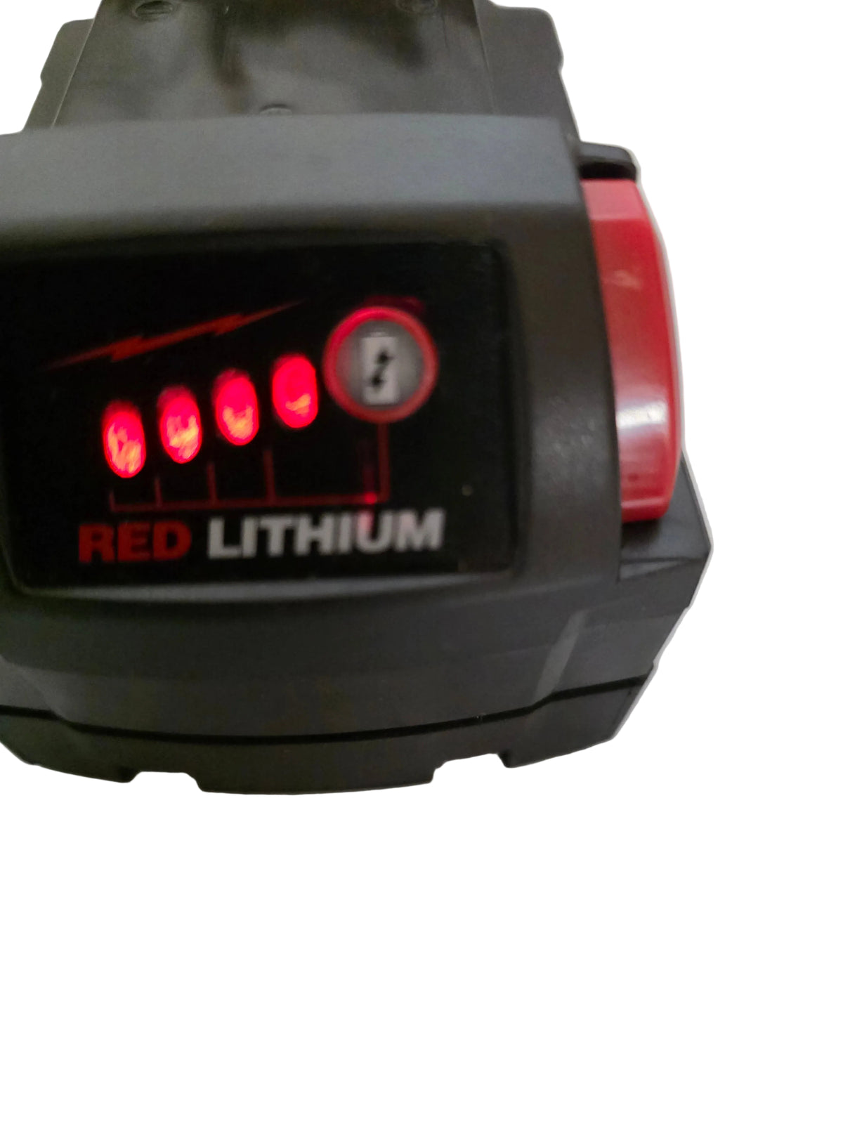A close-up of a RED LITHIUM battery pack, showing a black body with a red side button and illuminated red battery indicator lights on the front face.