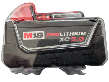 A M18 RED LITHIUM XC-5.0 cordless battery in its original clear plastic clamshell packaging, showing the black and red battery face.
