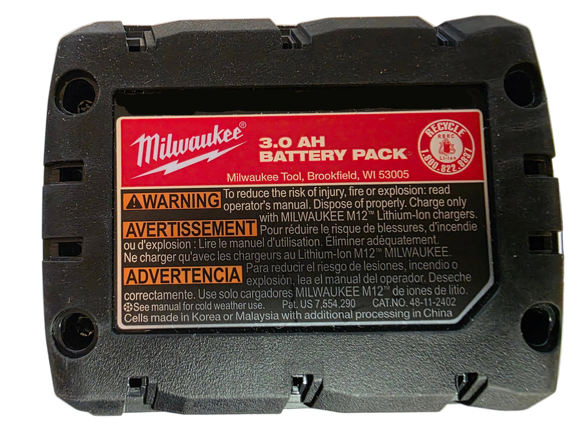 A Milwaukee 3.0-AH Battery Pack in black with a prominent red and white warning label on the back, photographed on a white surface.