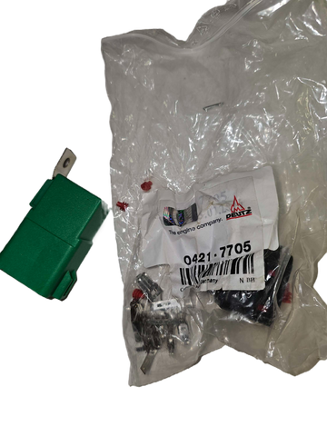 Green switch next to a plastic bag with automotive parts and a label.