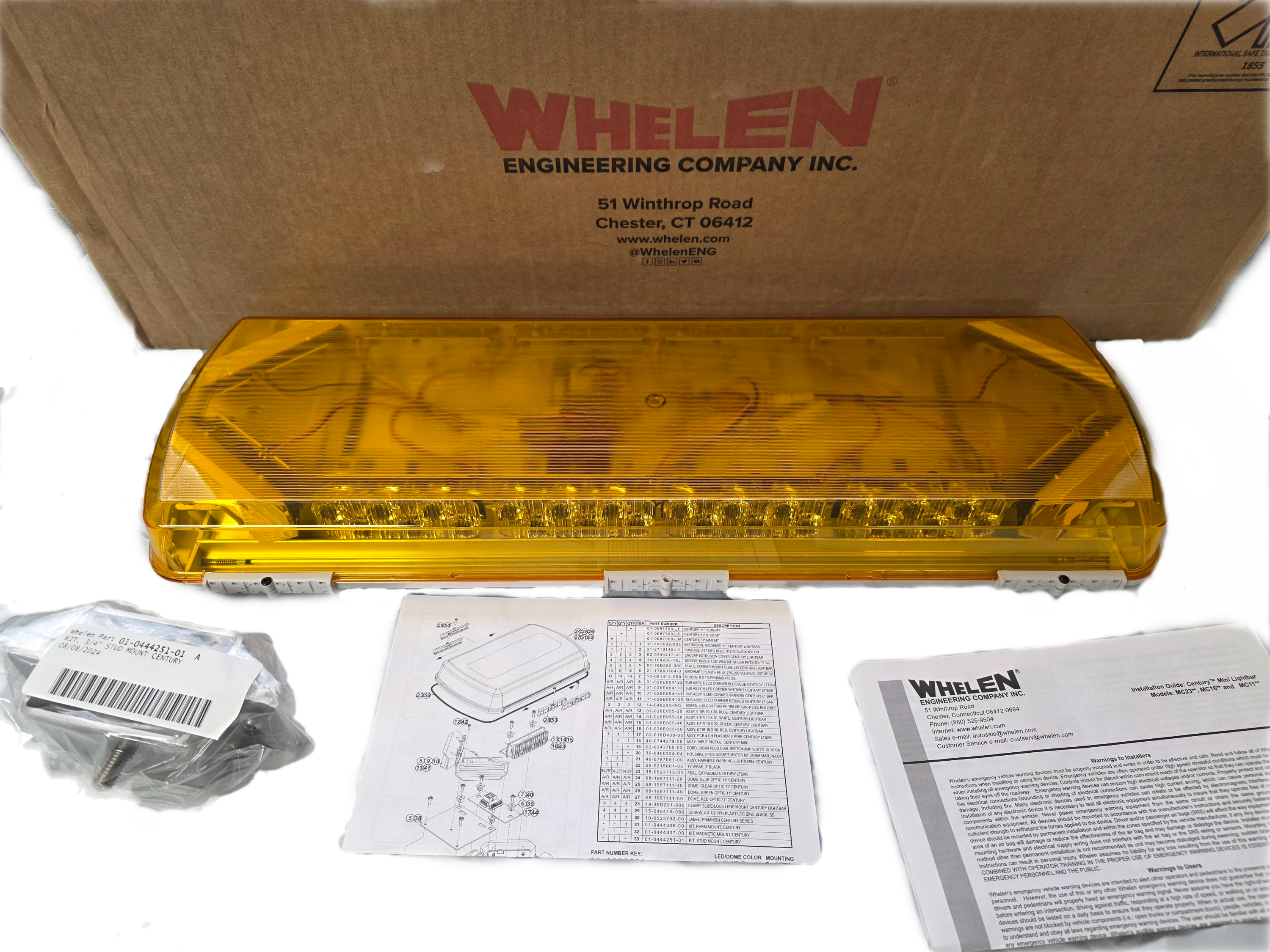 Yellow Whelen lightbar with packaging and documentation on a white background