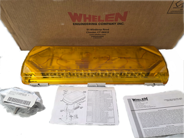 Yellow Whelen lightbar with packaging and documentation on a white background