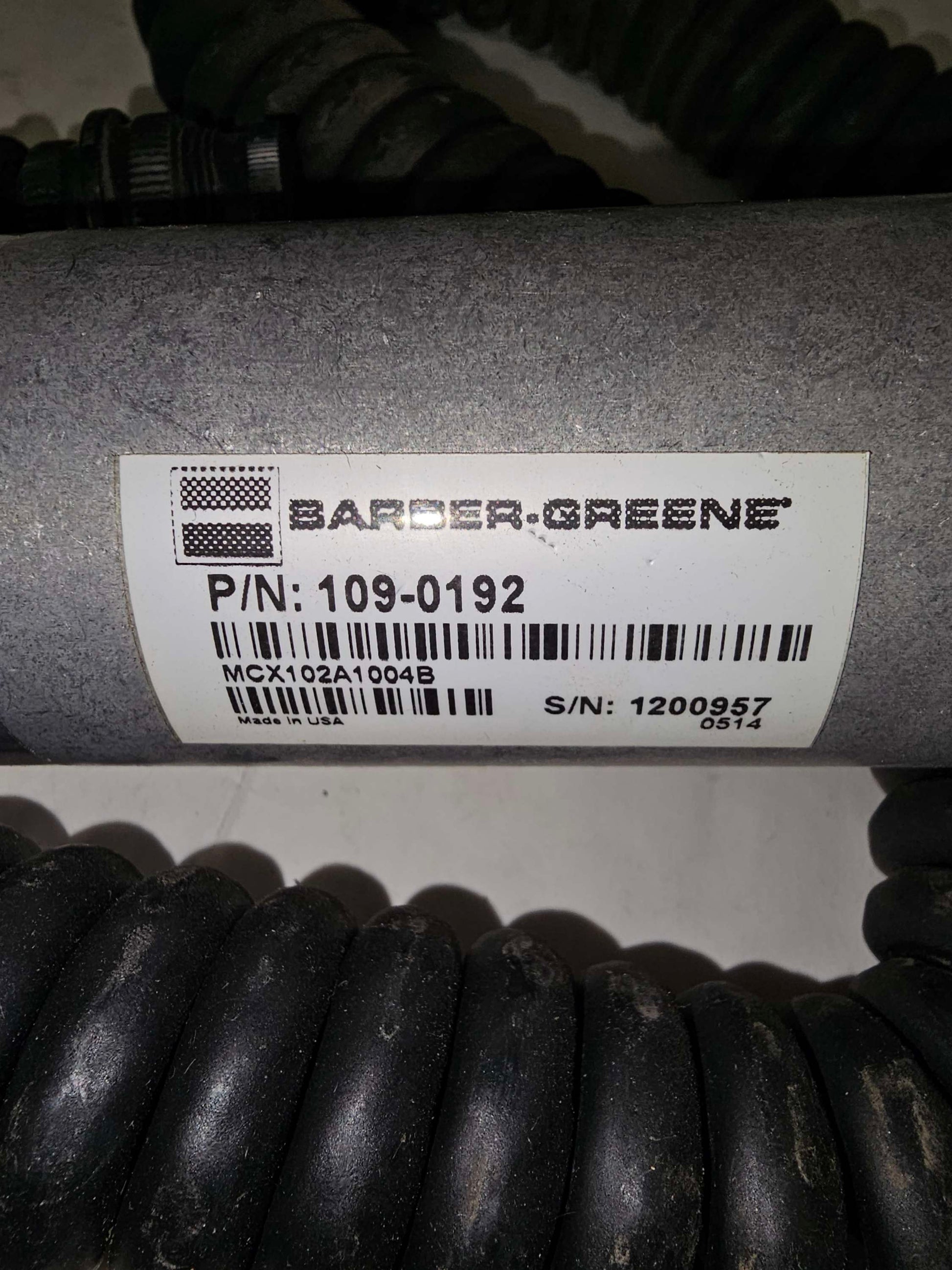 Barber-Greene product with label on a cylindrical metal component