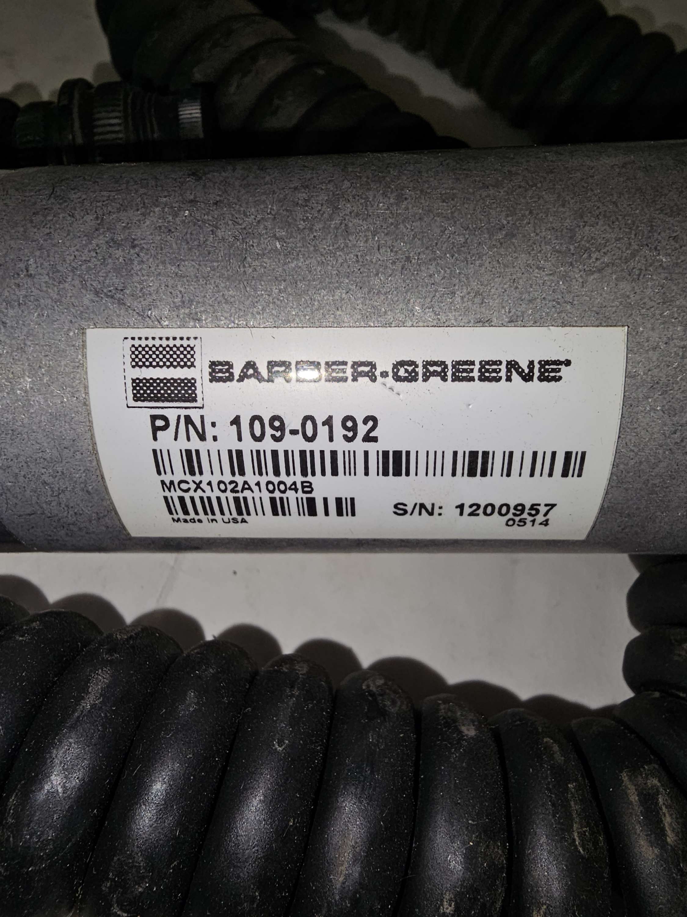 Barber-Greene product with label on a cylindrical metal component