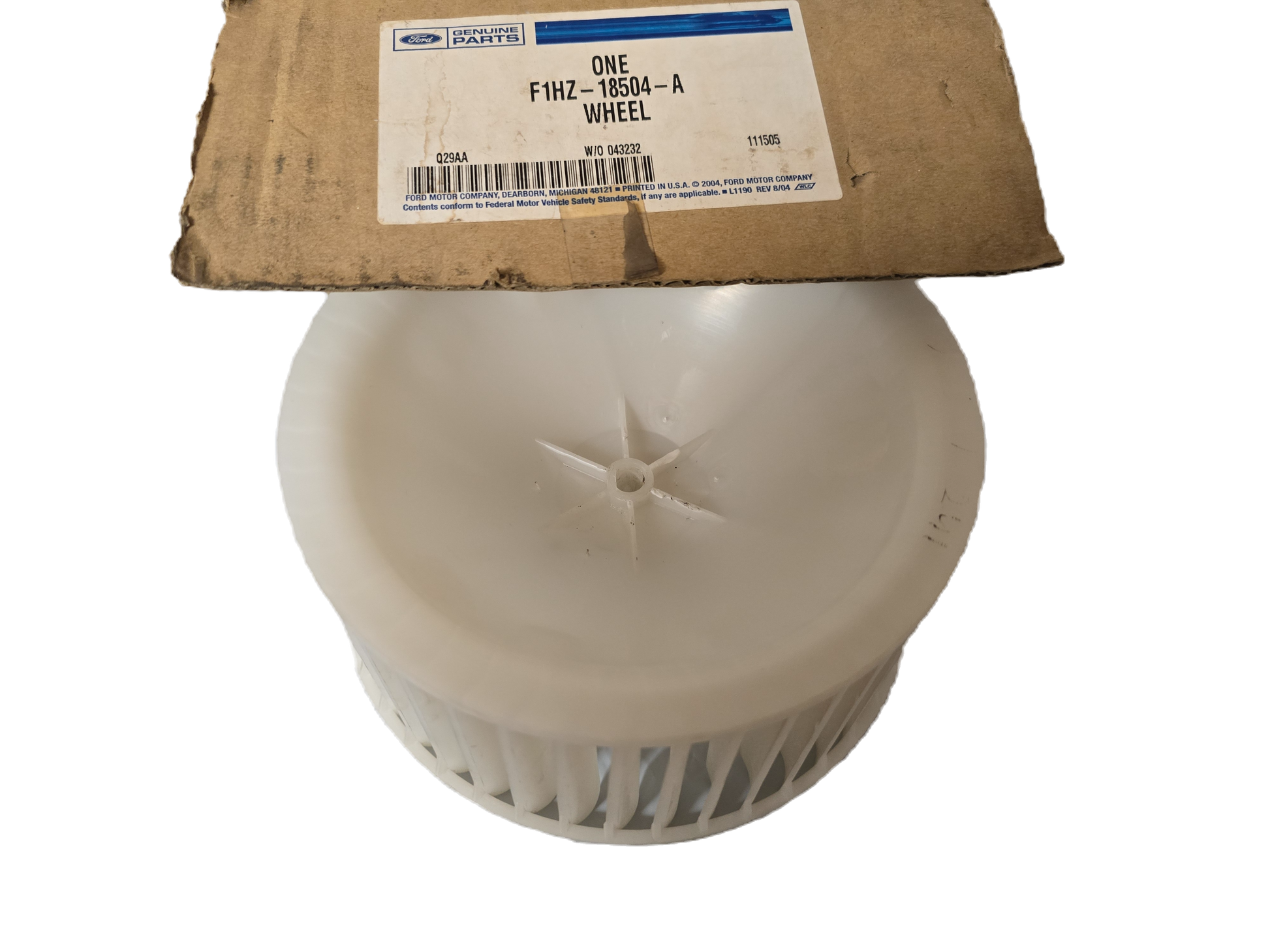 White wheel hub with a cardboard box labeled 'ONE' in the background