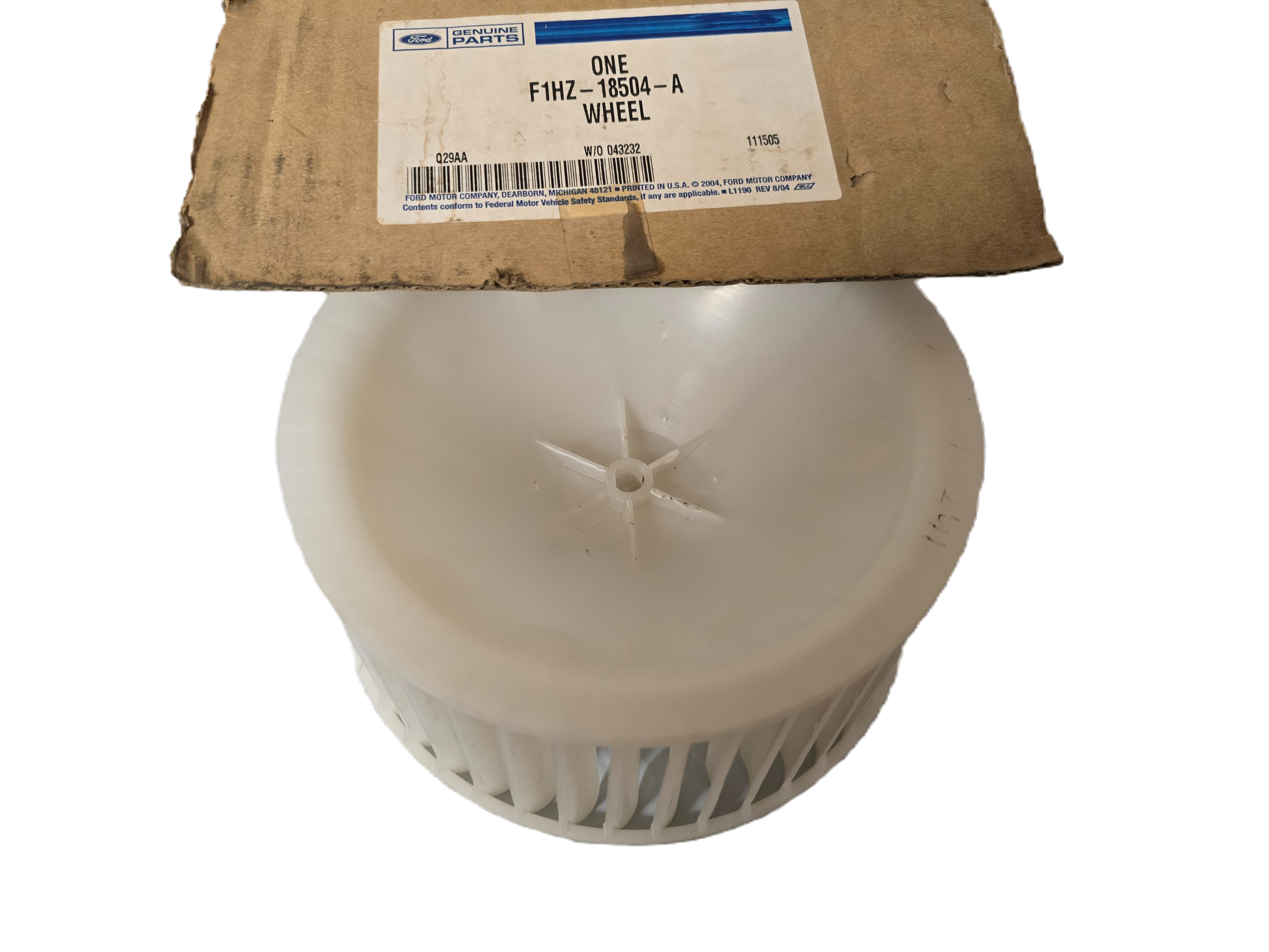 White wheel hub with a cardboard box labeled 'ONE' in the background