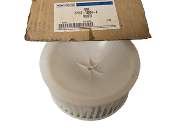 White wheel hub with a cardboard box labeled 'ONE' in the background