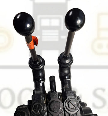 Close-up of a mechanical control panel with levers and buttons on a blurred background