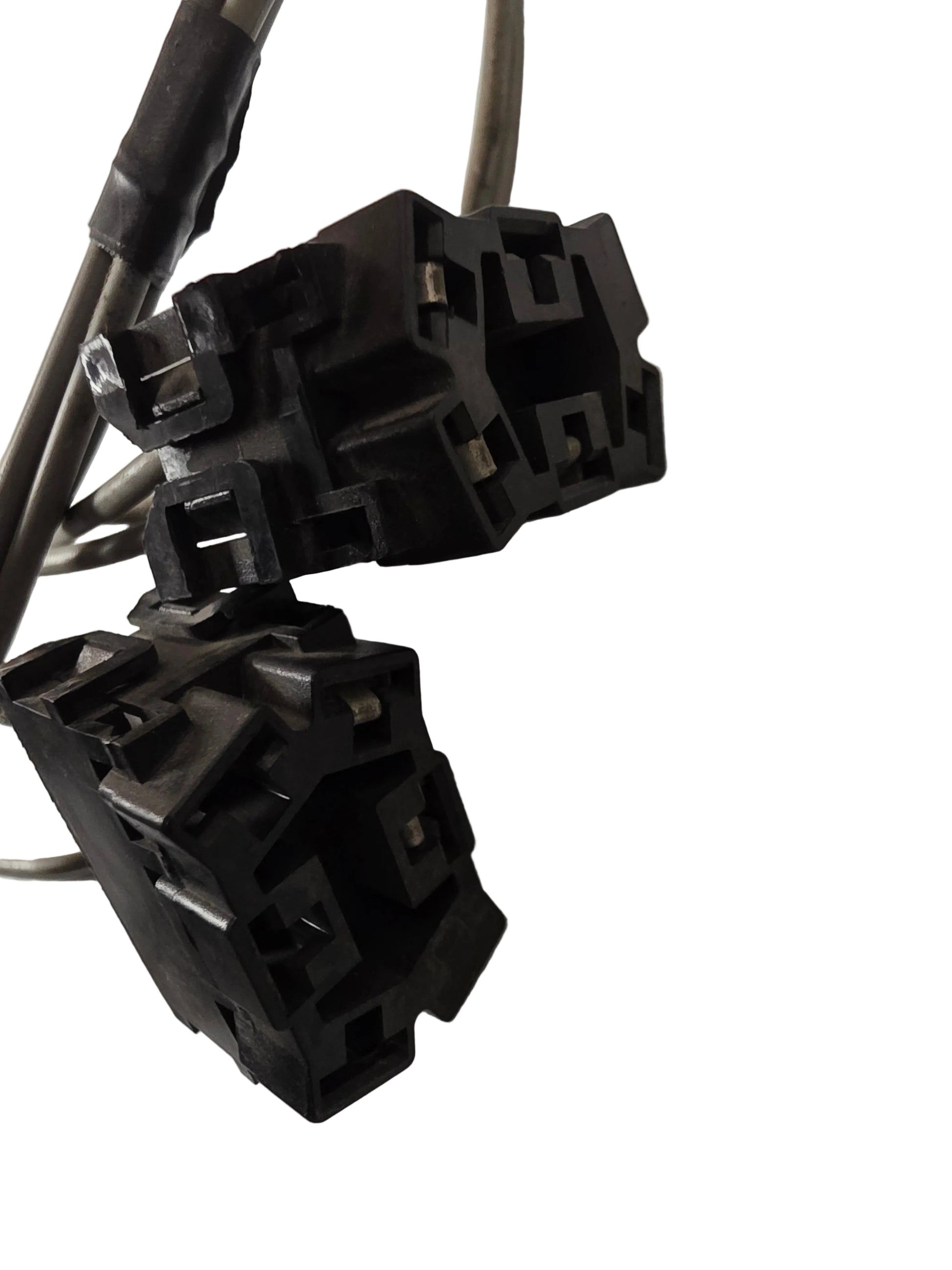 Two black plastic electrical connector sockets with attached wires, photographed on a light gray surface.