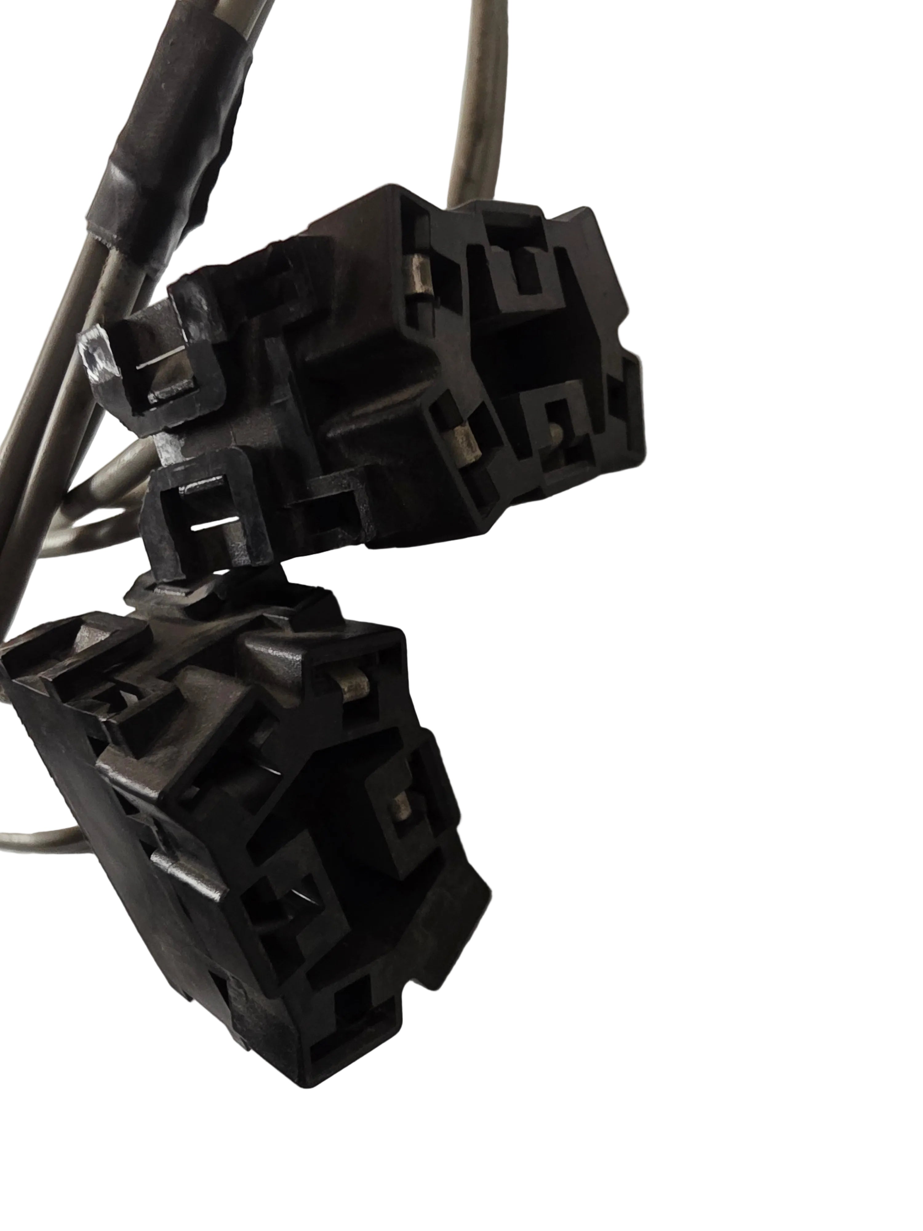 Two black plastic electrical connector sockets with attached wires, photographed on a light gray surface.
