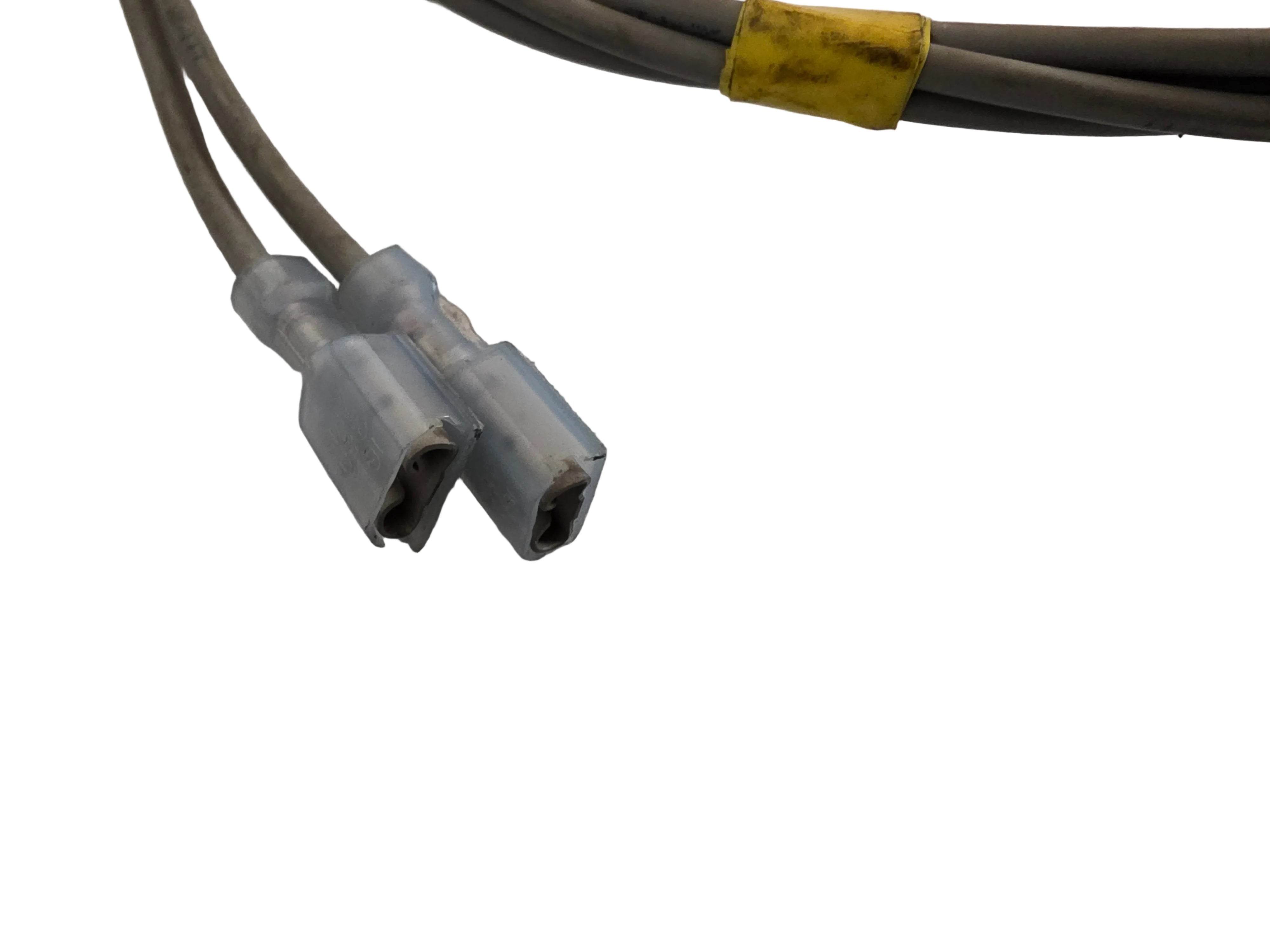 A close-up of a gray cable with two gray connector ends joined together by a translucent gray splice connector, with a yellow tape wrap on the cable, set against a white background.
